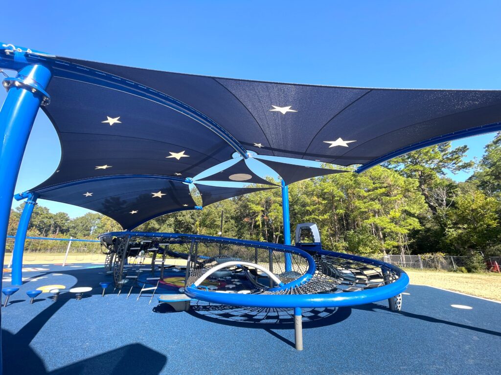 large shade sails covering playground equipment