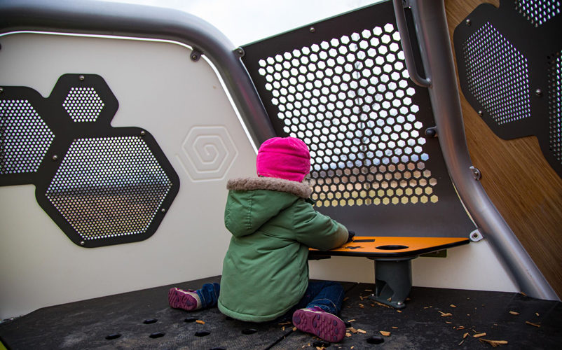 child playing in hedra