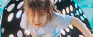 girl walking through play equipment