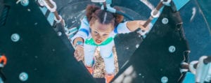 girl climbing on play equipment